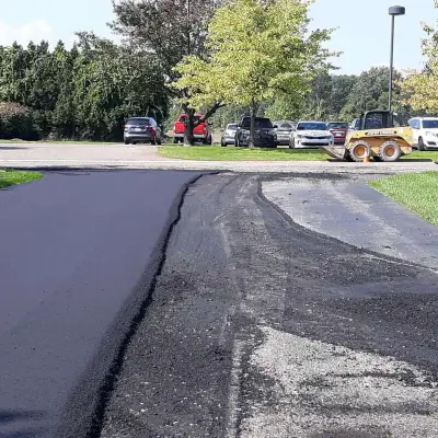 Fresh asphalt edge on a resurfaced lot